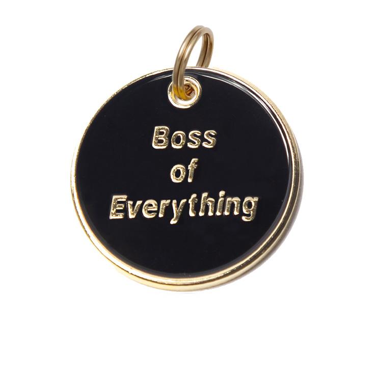 Round black dog tag with gold border, top ring, and “Boss of Everything” text