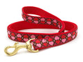 Red dog leash with pink heart pattern and brass clasp, fabric loop handle