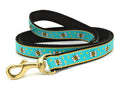 Bee-pattern dog leash with turquoise webbing, black trim, and gold metal clasp