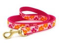 Pink floral dog leash with orange and yellow flower print and brass clip, 5 ft