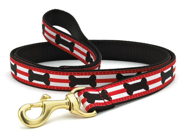 Red and white striped dog collar with black bone graphics, brass hardware and D-ring