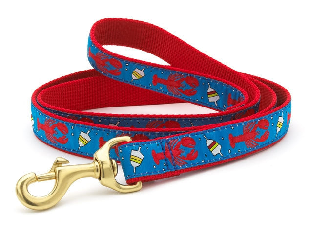 Red and blue printed dog leash with lobster and buoy pattern; brass trigger clip