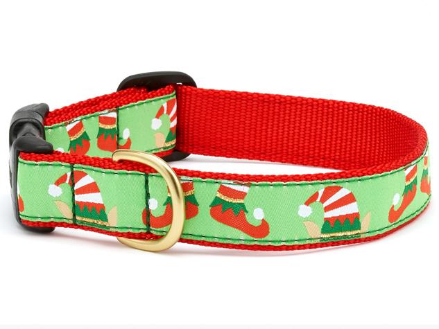 Holiday patterned dog collar with red strap and green festive print, brass buckle