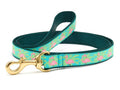 Dog leash with teal webbing, flamingo print strap, and brass swivel clasp