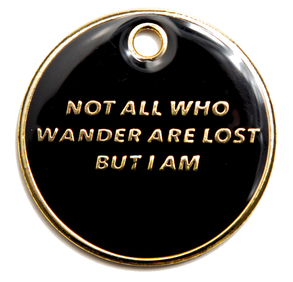 Black round dog ID tag with gold engraved text and metal hanging ring at top