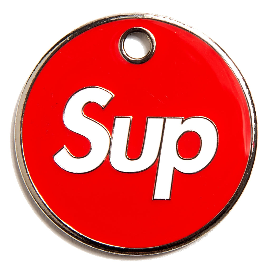 Red circular dog ID tag with chrome edge, 'Sup' logo, and hanging hole