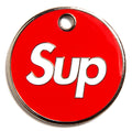 Red circular dog ID tag with chrome edge, 'Sup' logo, and hanging hole