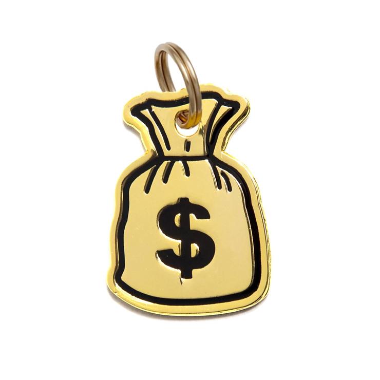 Gold-tone money bag dog tag charm, side view with dollar sign and ring loop.