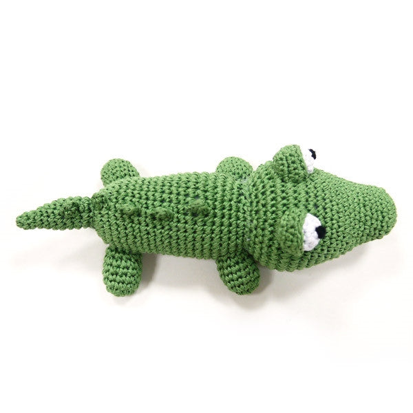 Green crocheted alligator dog toy with squeaker, curled body and raised legs