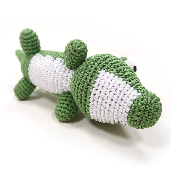 Green crocheted alligator dog toy with squeaker, white belly panel and toothy snout