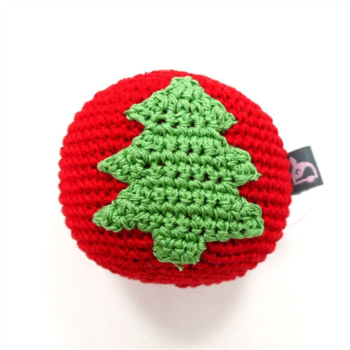 Crocheted dog toy ball with green tree applique, red yarn, and fabric label