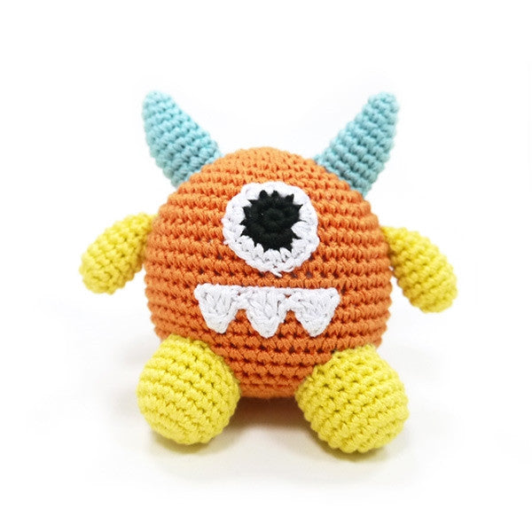 Crocheted monster dog toy with squeaker, orange head, blue horns, yellow legs and arms