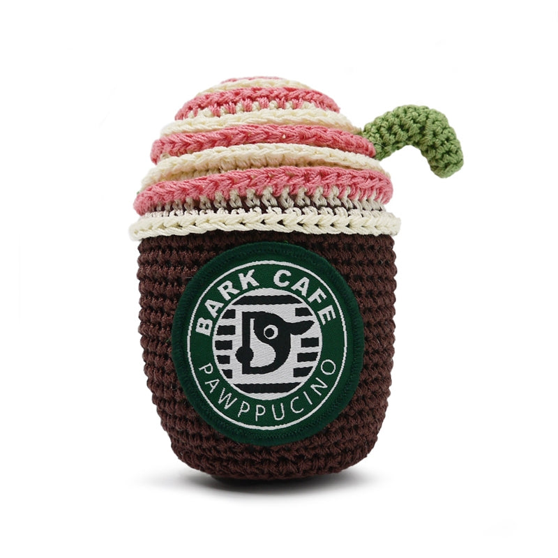 Front view crochet dog toy coffee cup, dark brown with pink/cream rim, green handle and Bark Cafe logo