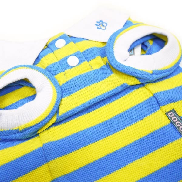 Close-up of dog polo shirt fabric: yellow and blue stripes with white trim and button.