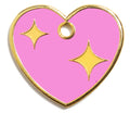 Pink heart dog tag close-up with gold rim, two yellow stars, and round top loop