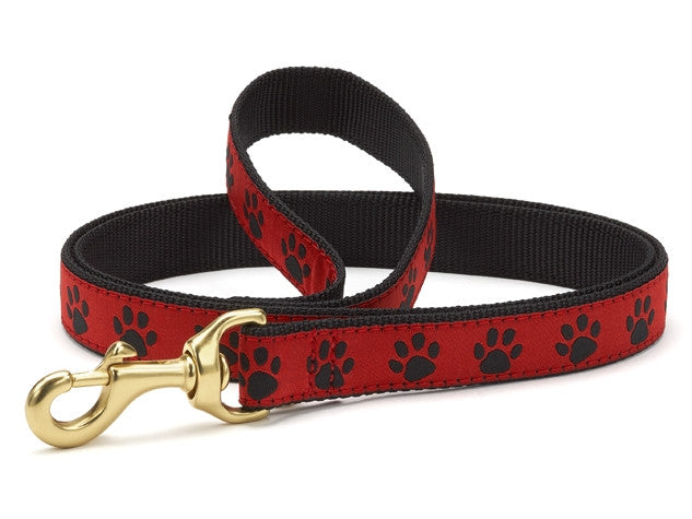 Red and black paw-print dog leash with brass clip and loop handle