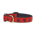 Dog collar with red fabric and black paw prints, black trim, and gold buckle
