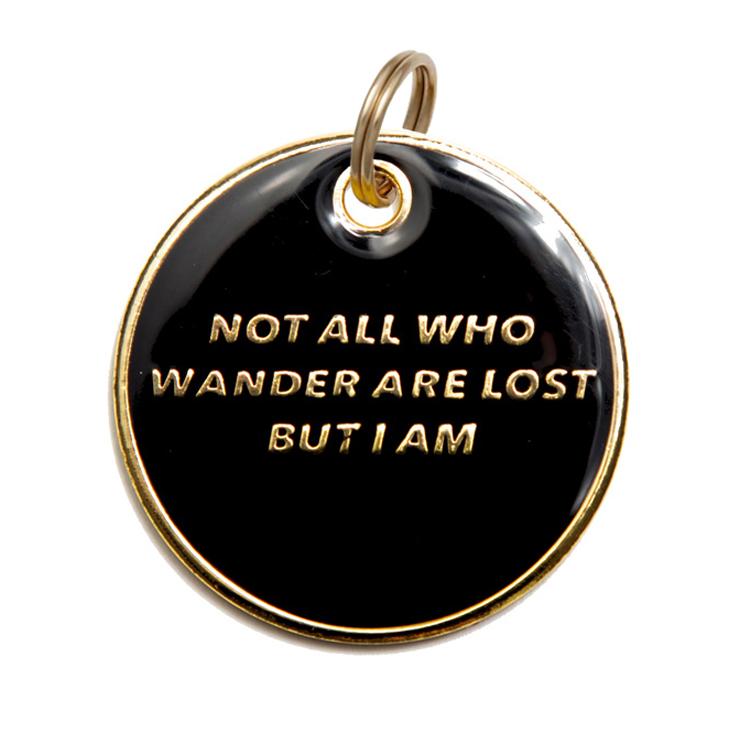 Black round dog ID tag with gold engraved quote and looped metal bail