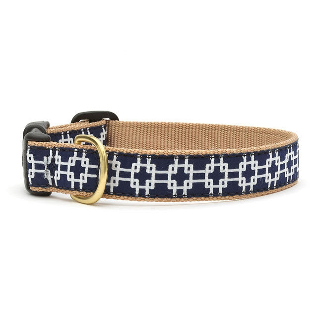Woven dog collar with tan webbing and navy grid pattern, brass buckle and D-ring