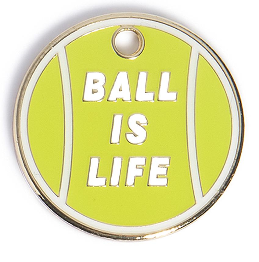 Round green dog tag with white text “BALL IS LIFE” and metal rim