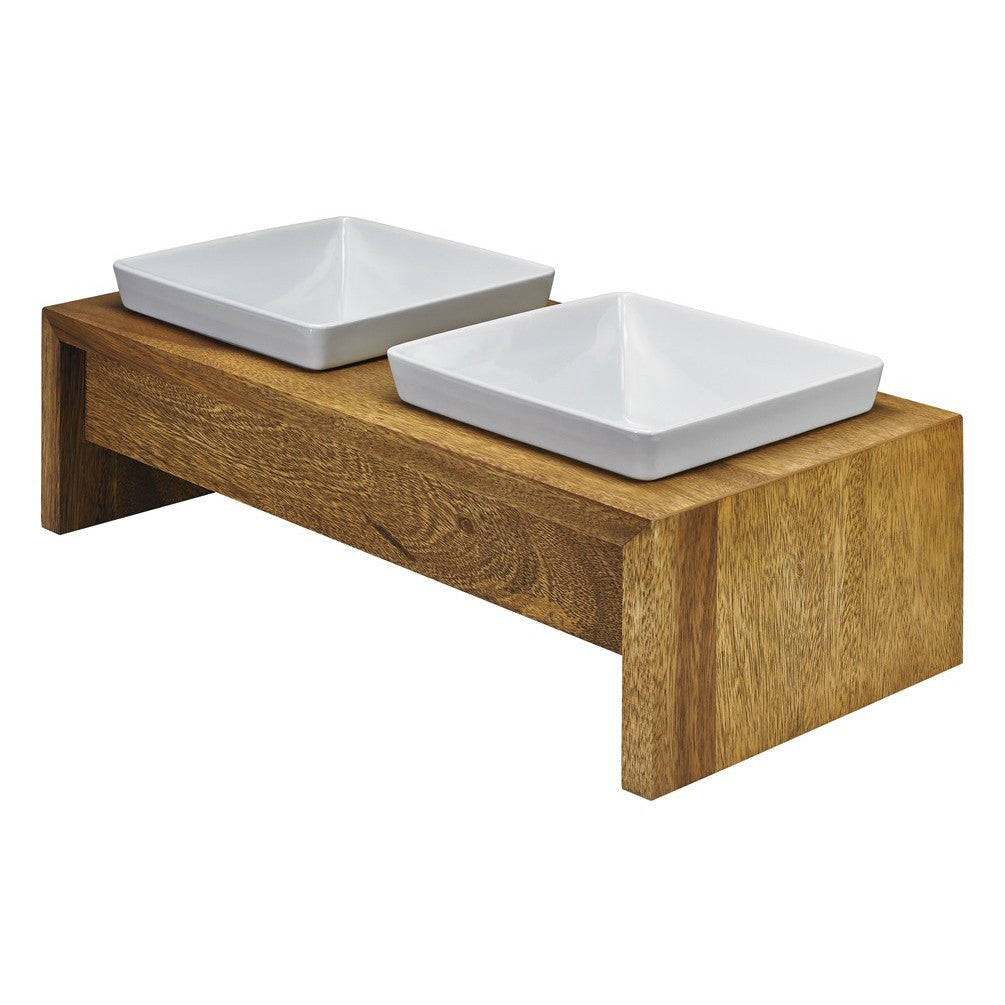 Natural bamboo dog feeder with two white square bowls on a raised wooden stand.