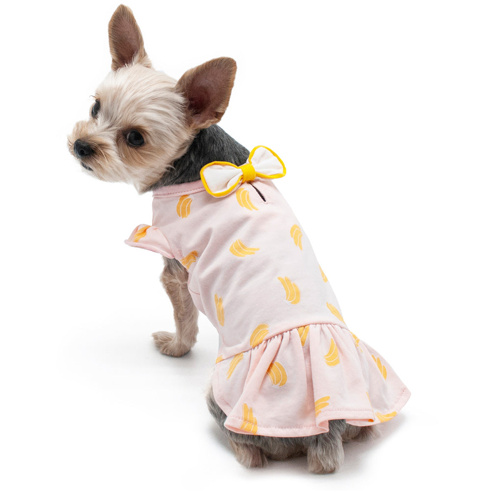 Pink banana-print dog dress with yellow bow at the neck