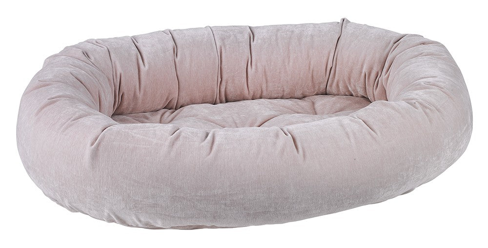 Blush microvelvet donut dog bed with raised bolsters and soft padded rim