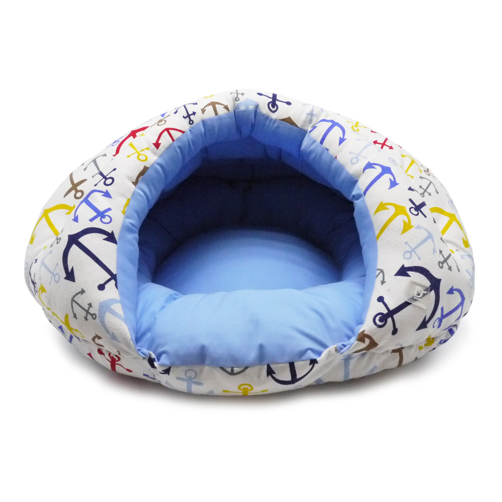 Round small dog snuggle bed with anchor print outer and light blue donut-shaped cushion