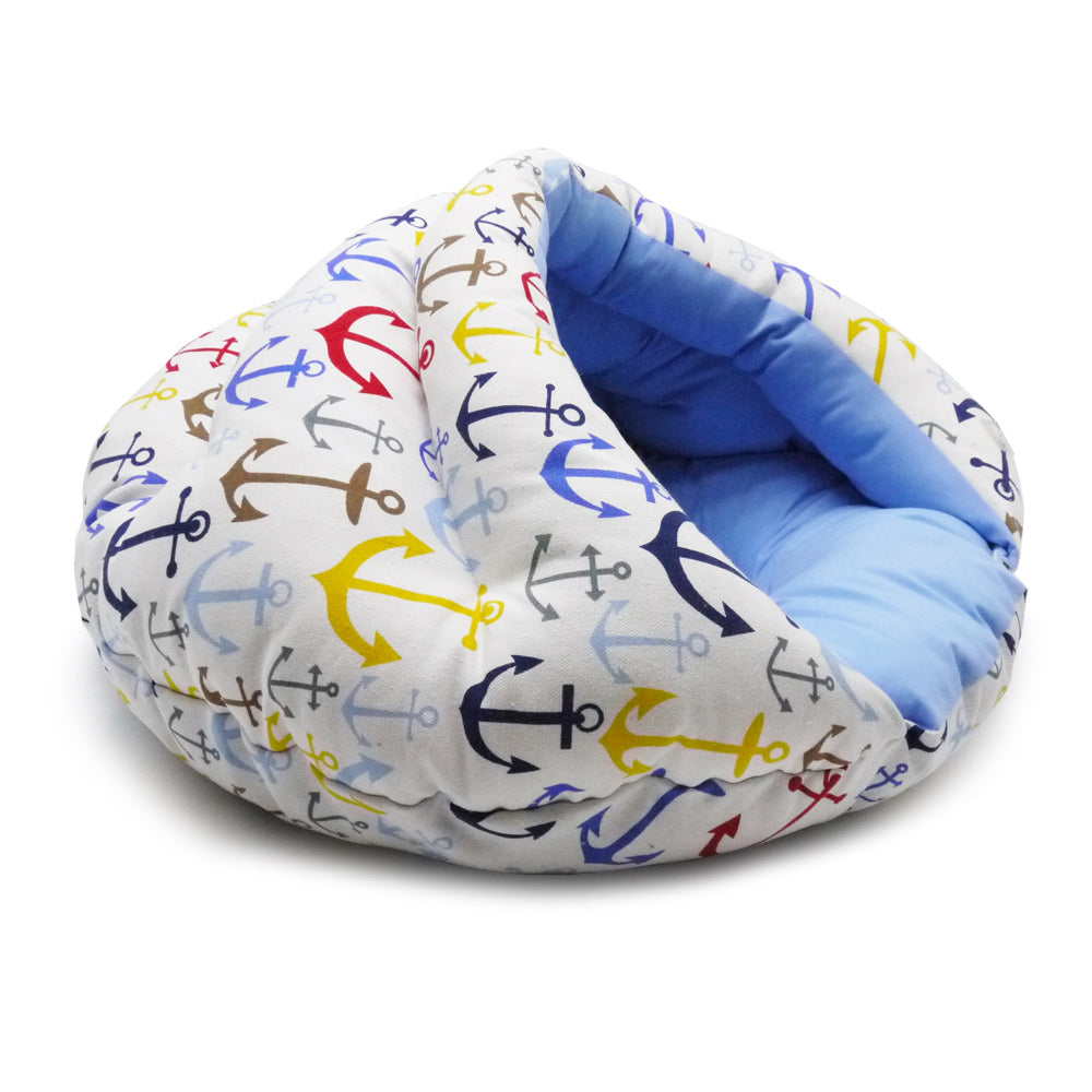 Small dog snuggle bed with blue anchor print and light blue padded inner cushion