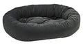 Dark charcoal donut-shaped dog bed with plush bolstered sides and flat center