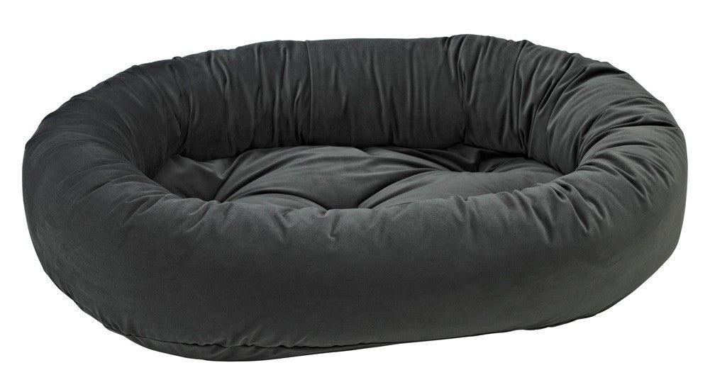 Dark charcoal donut-shaped dog bed with plush bolstered sides and flat center