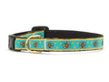 Bee-pattern cat collar with turquoise fabric, black strap, and brass buckle