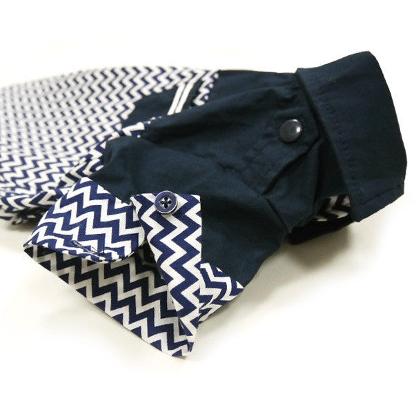 Navy dog shirt with white zigzag chevron panels and round snap buttons on front.