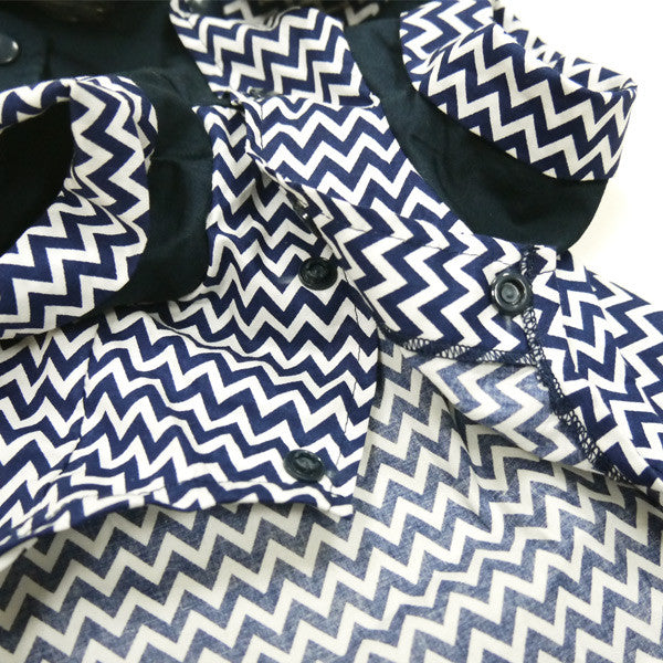 Chevron dog shirt fabric close-up with navy buttons and zigzag pattern across chest.