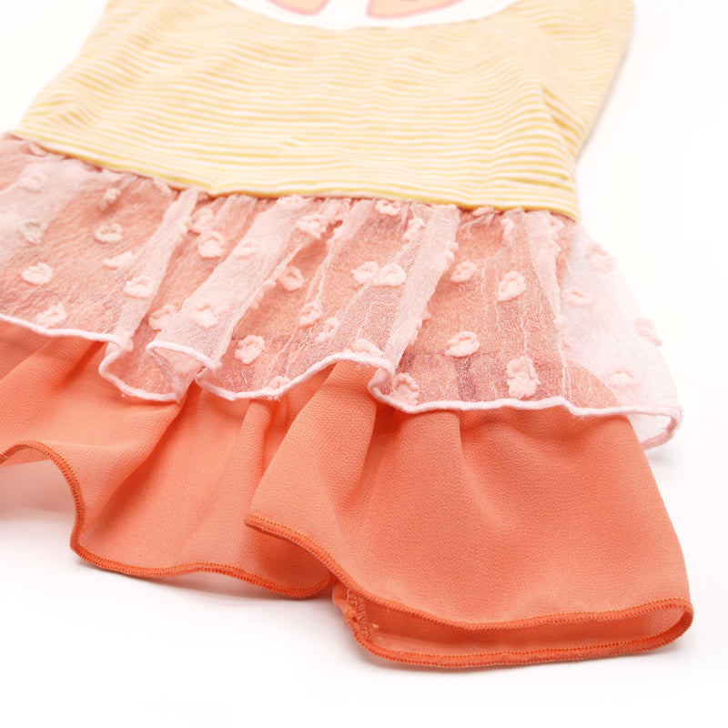 Ruffled orange and pink skirt detail with translucent tulle overlay on citrus dog dress