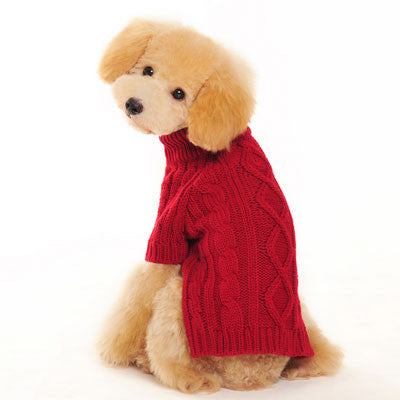 Red cable-knit dog sweater with textured diamond pattern, worn by sitting dog