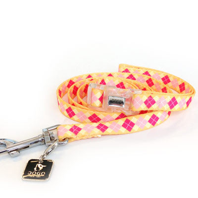 Pink and yellow argyle dog collar with metal buckle, D-ring, and branded tag