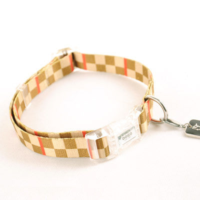 Checker-pattern dog collar in tan with red accents; clear buckle and D-ring