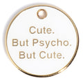 Round gold dog tag with text "Cute. But Psycho. But Cute." and hanging hole