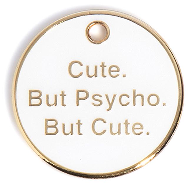 Round gold dog tag with text "Cute. But Psycho. But Cute." and hanging hole