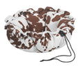 Brown-and-white cowprint pet bed with plush trim and tied drawstring