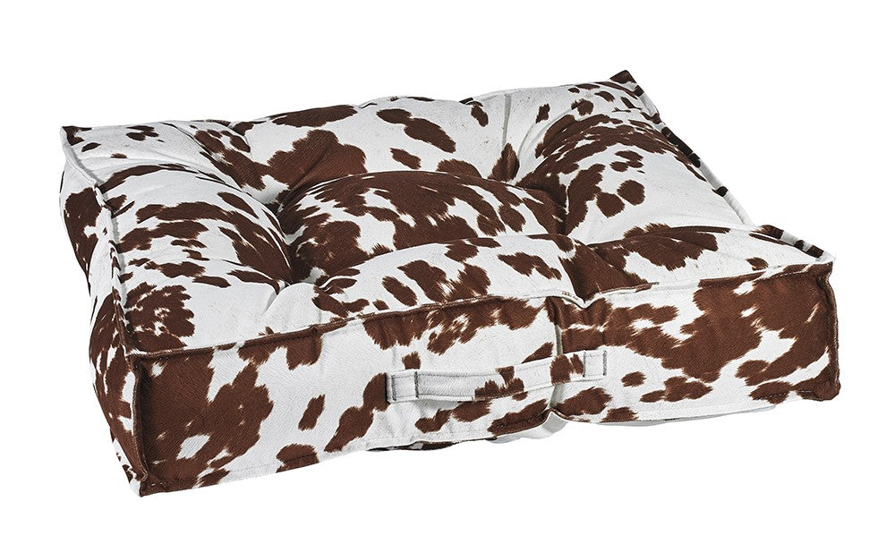 Brown-and-white microvelvet dog bed with pinched edge, tufted top and raised sides