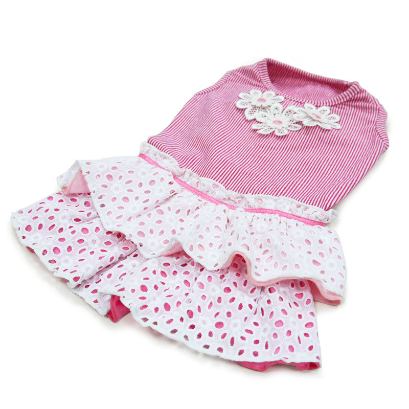 Dog dress lying flat: pink striped top with white eyelet flower detail and ruffled skirt