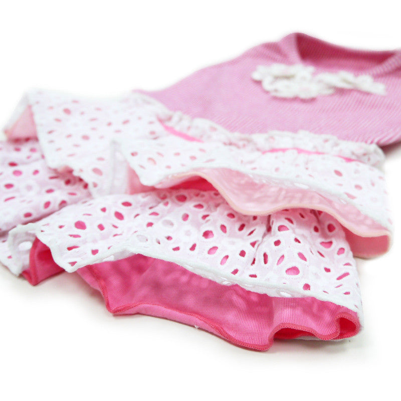 Close-up of tiered skirt on pink striped dog dress with white eyelet dot ruffles