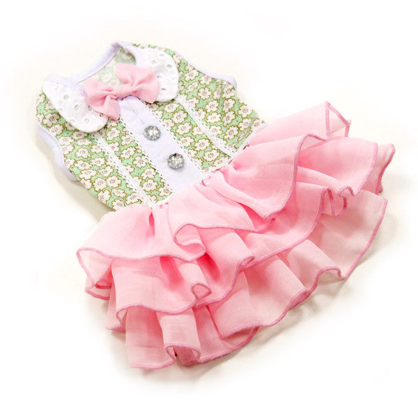 Dog dress with green floral vest, pink bow, sparkly buttons, and layered ruffle skirt