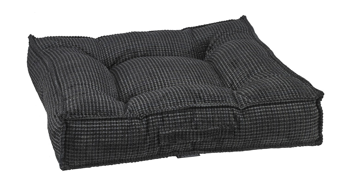 Dark gray chenille dog bed with cushioned, tufted bolsters and built-in base