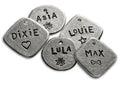 Hand-stamped round dog ID tags with engraved names, hearts, and symbols, aluminum