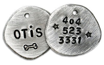 Hand-stamped round dog ID tags: OTIS and 404/523/3531 with bone and star symbols