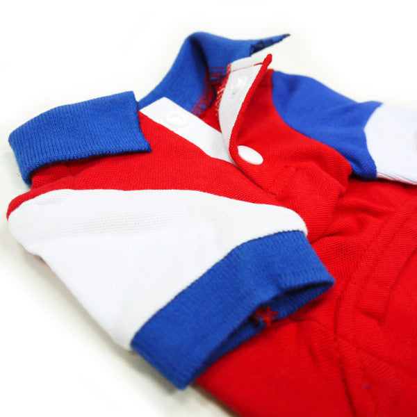 Close-up red dog polo shirt with blue knit cuffs and white button placket
