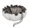 Marshmallow dog bed with gray plush center, white ruffled sides, black drawstring